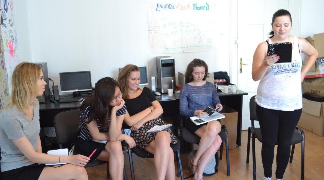 Teenage volunteers work as a group to find the best stories for the magazine Journalism volunteers discuss their story ideas as part of their Journalism Project for teenagers